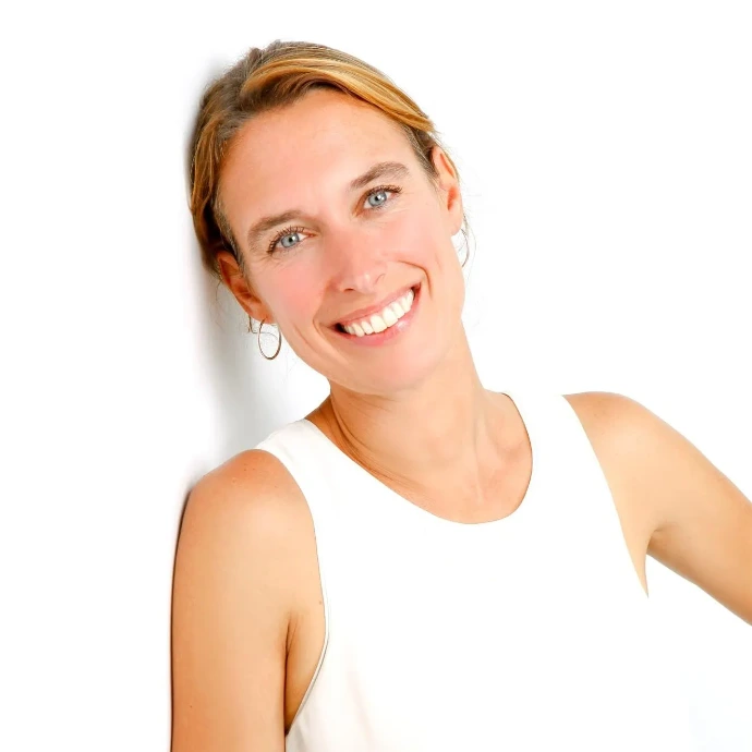 Event and Project Manager Yolanda, smiling in front of a white wall.