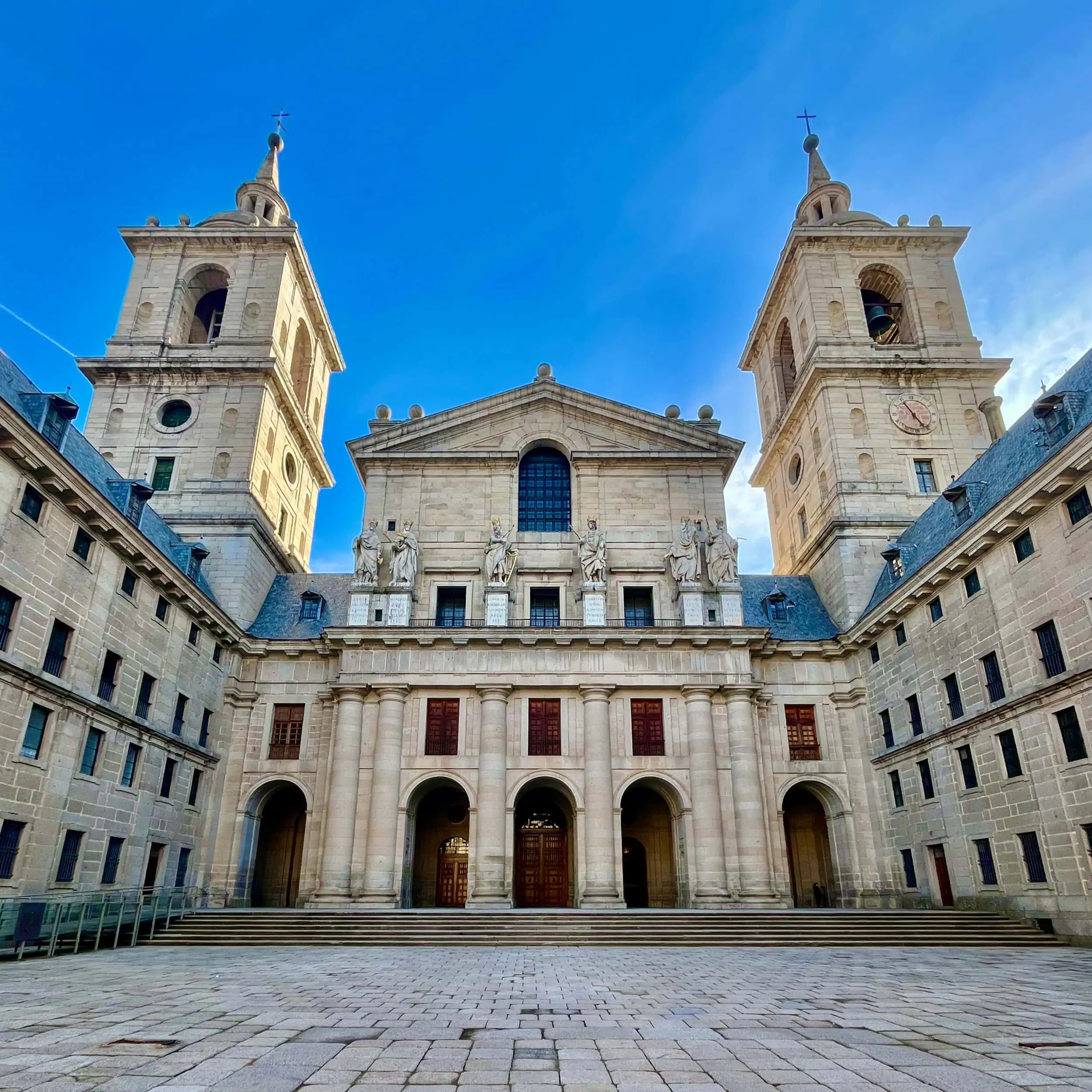 The monumental façade of the Monastery of El Escorial, where religion, power, and architecture converge.